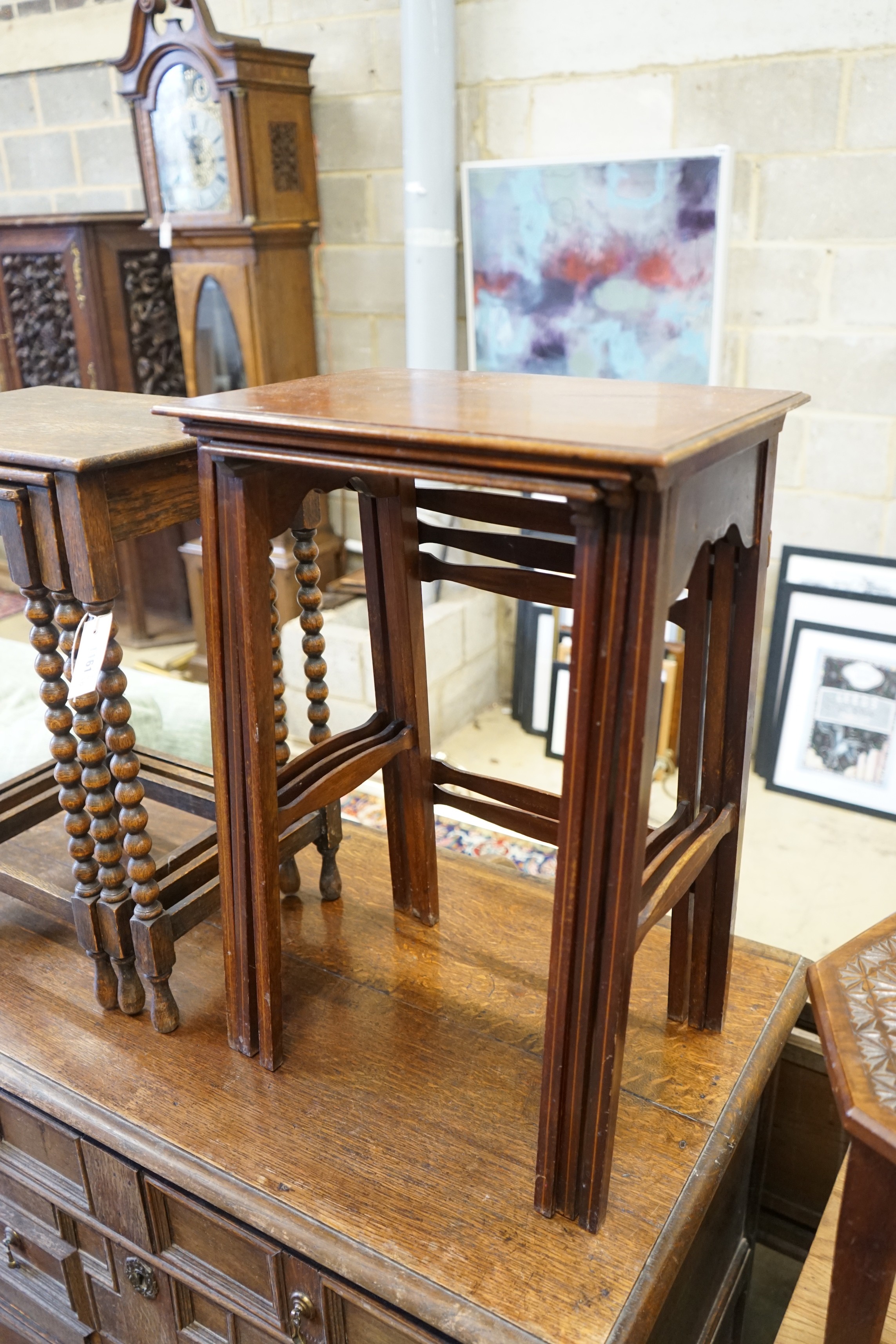 A nest of three Edwardian mahogany tea tables, height 61cm, a nest of three oak tea tables and an octagonal carved occasional table